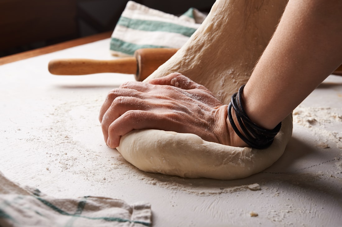 Hands folding tomorrow's dough