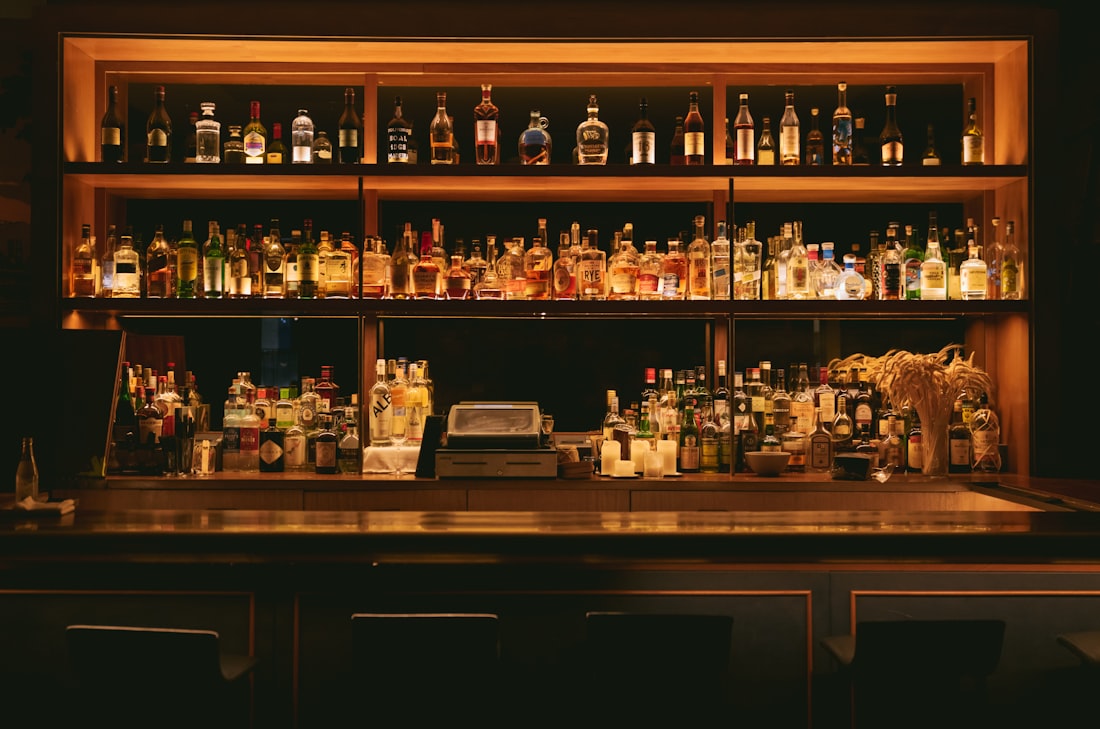 The Golden Hour back bar, lit amber
