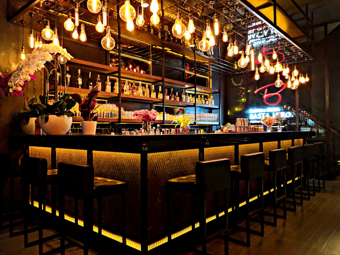 The room — a hundred filament bulbs over the bar