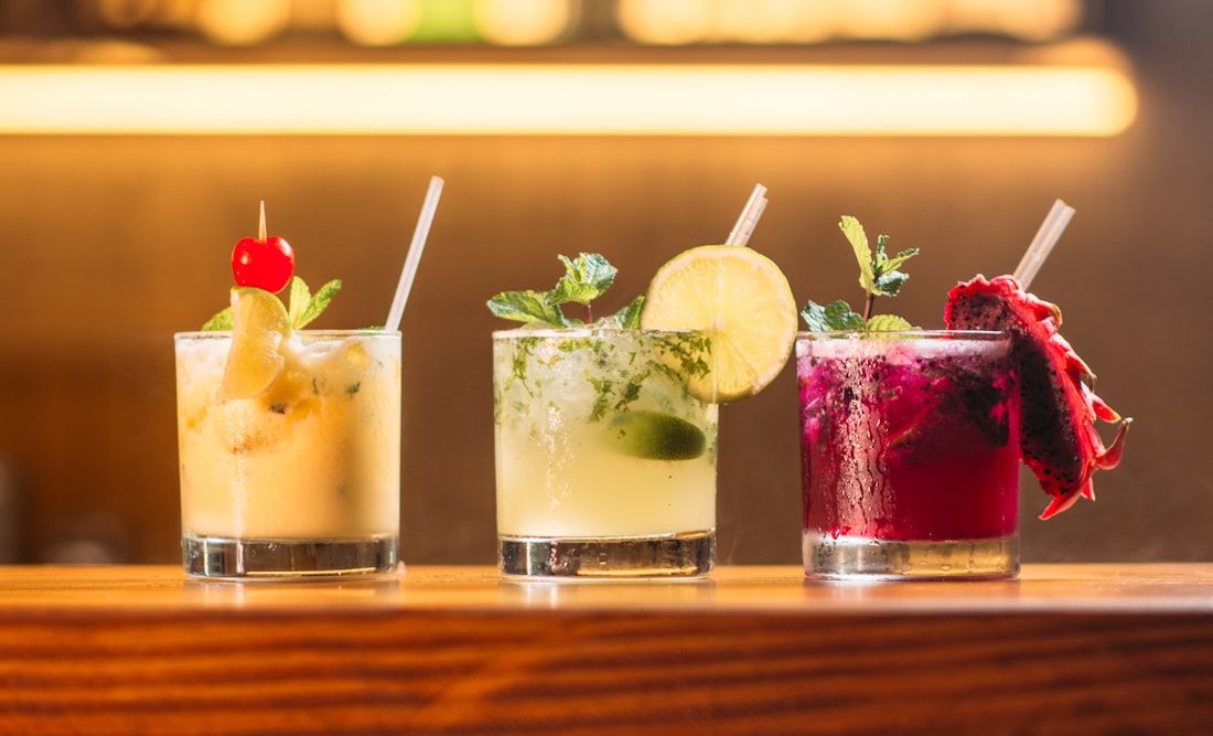 Three house cocktails lined up on the bar