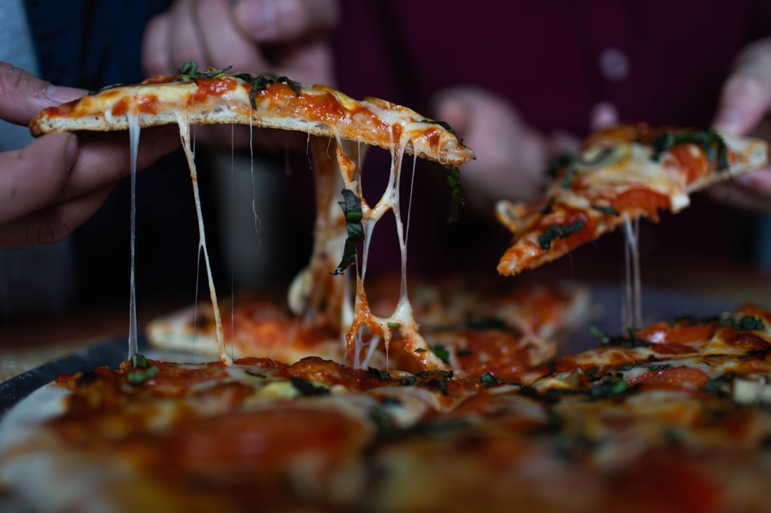 Hands pulling slices apart over the table